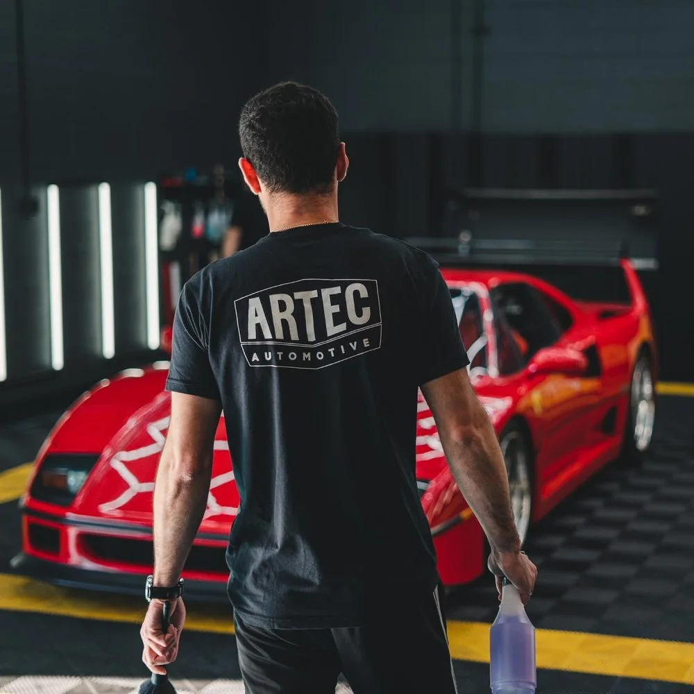Artec Automotive technician walking toward a red Ferrari F40 on the shop floor in Belmont, CA