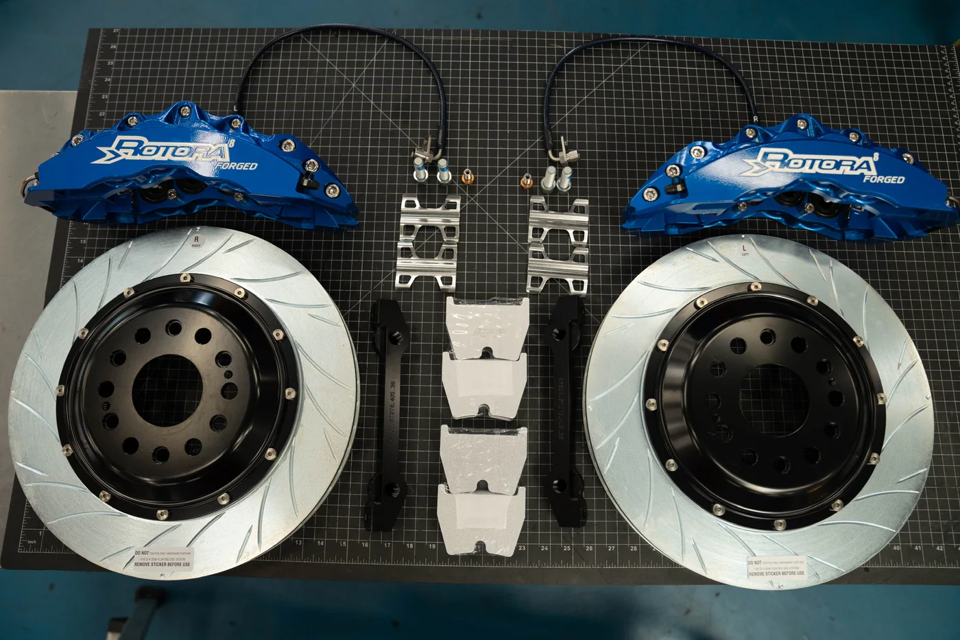 Big brake kit with drilled rotors and blue calipers ready for fitting