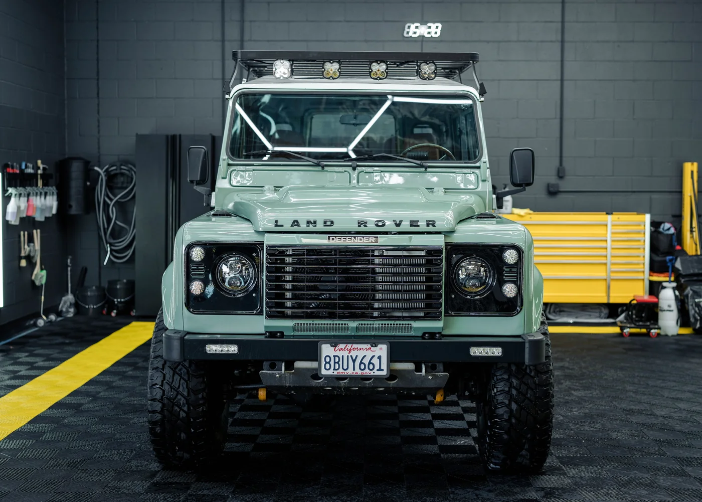 Green Land Rover Defender parked in the Artec Automotive workshop