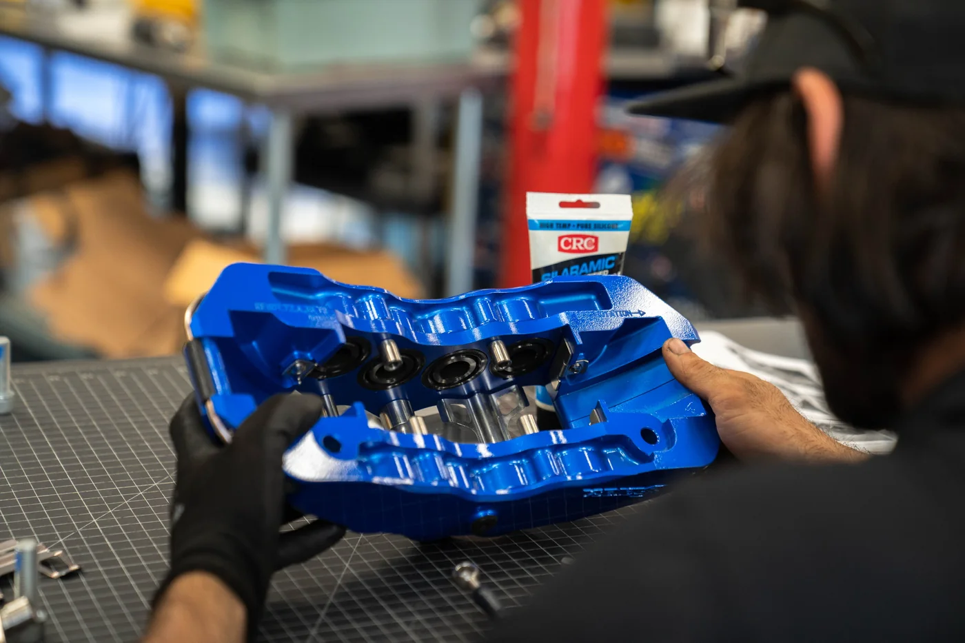 Technician working on a bare metal panel during a race car build