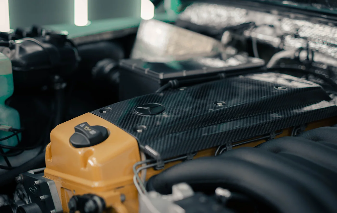 Carbon fibre bonnet and engine detail on a performance build
