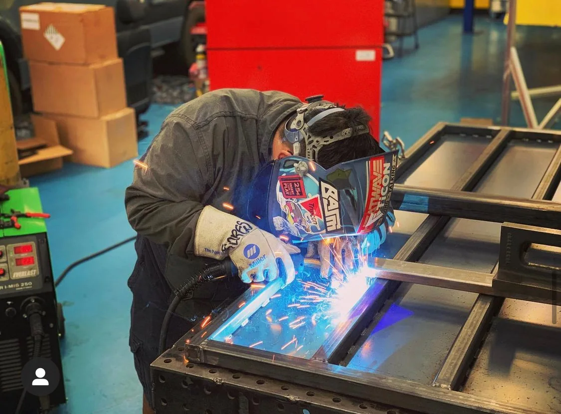 Technician TIG welding a steel fabrication in the Artec Automotive shop