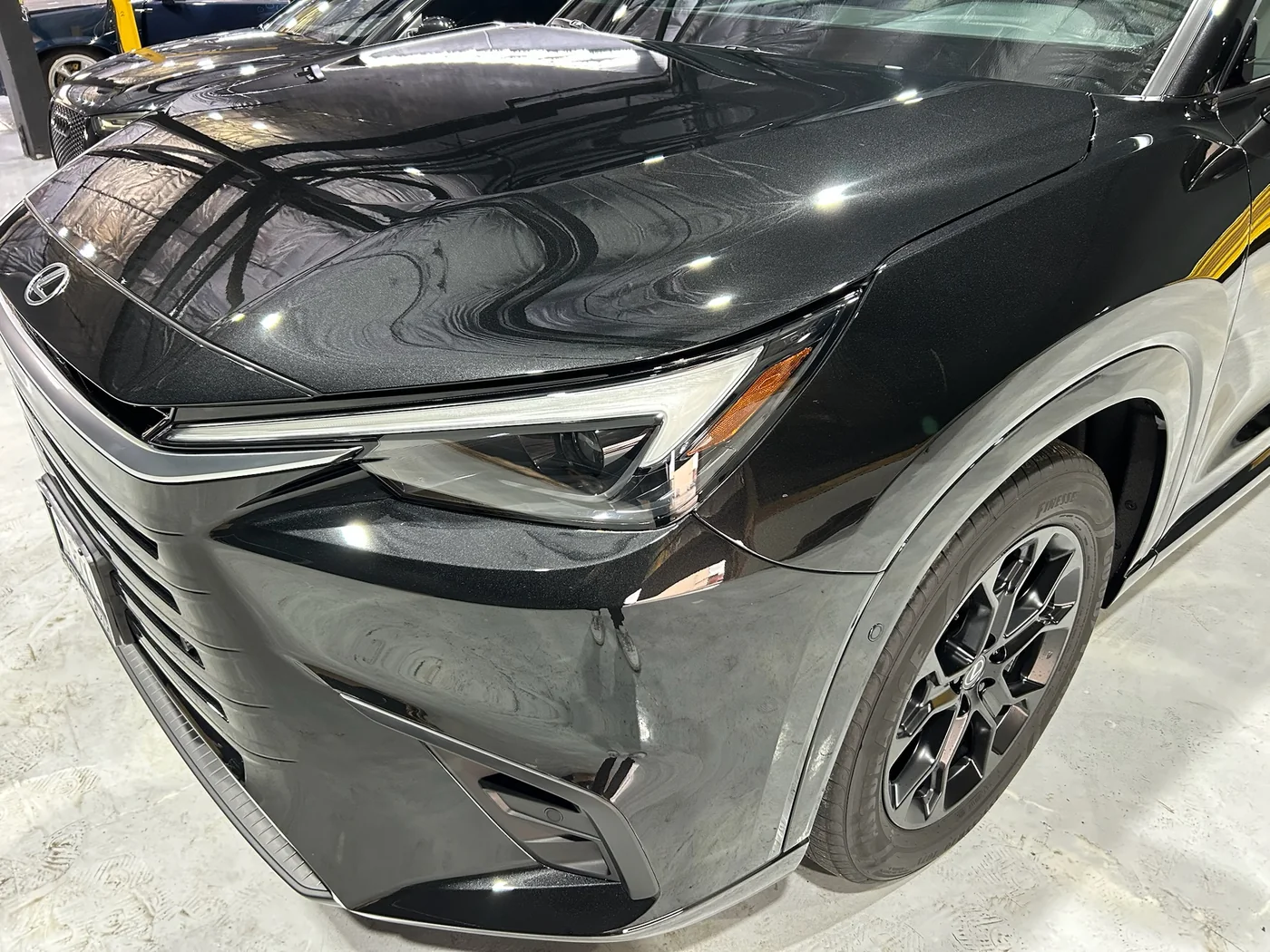 Black SUV front wing and headlight finished in paint protection film