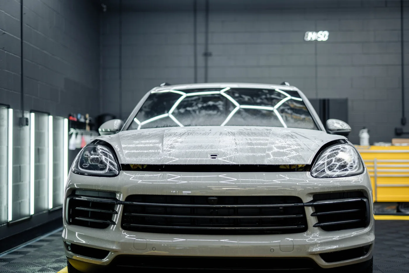 Porsche Cayenne with paint protection film wet-laid across the bonnet and front bumper