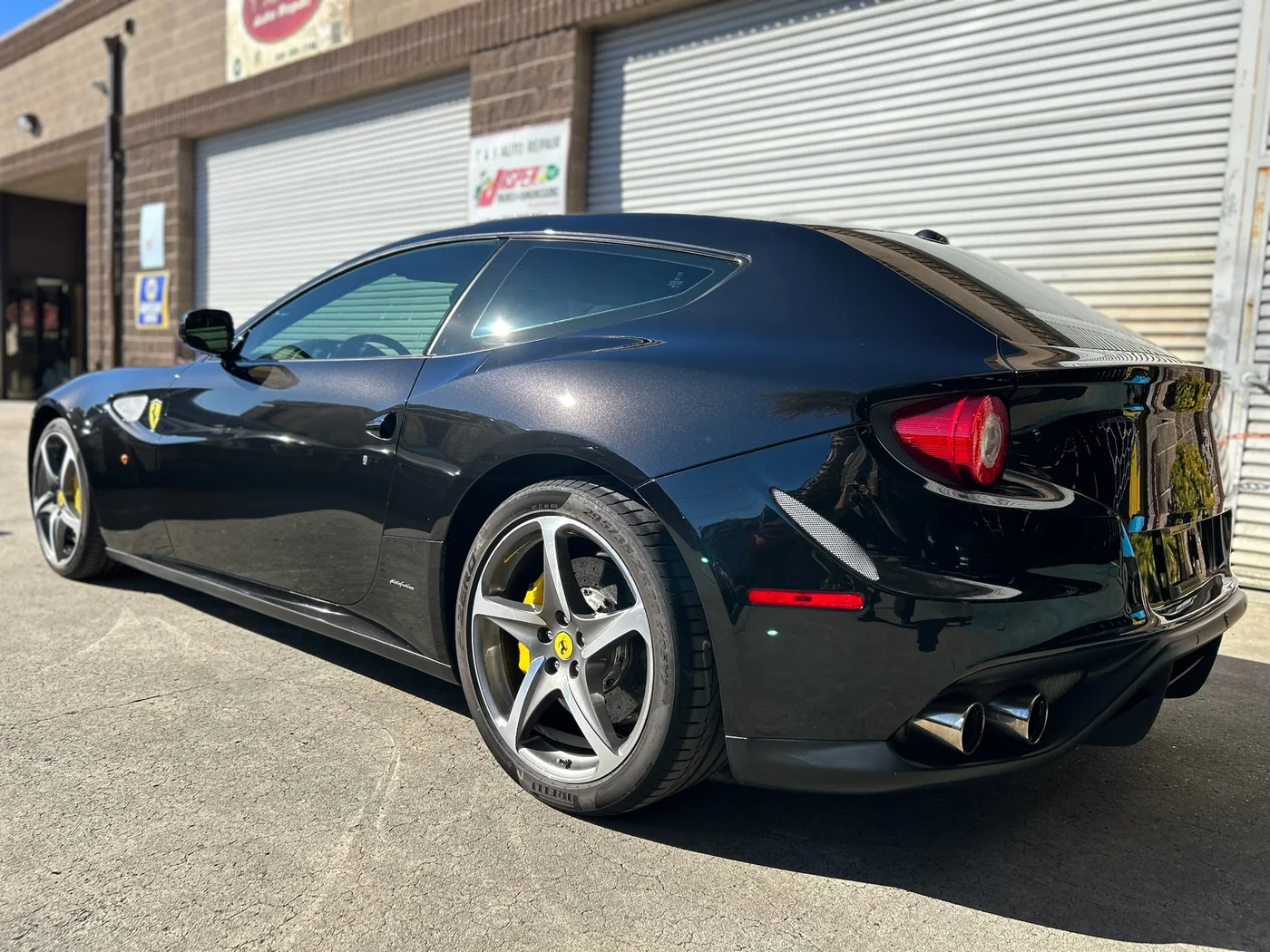Black Ferrari FF photographed rear three-quarter outside the Artec Automotive shop in Belmont, CA