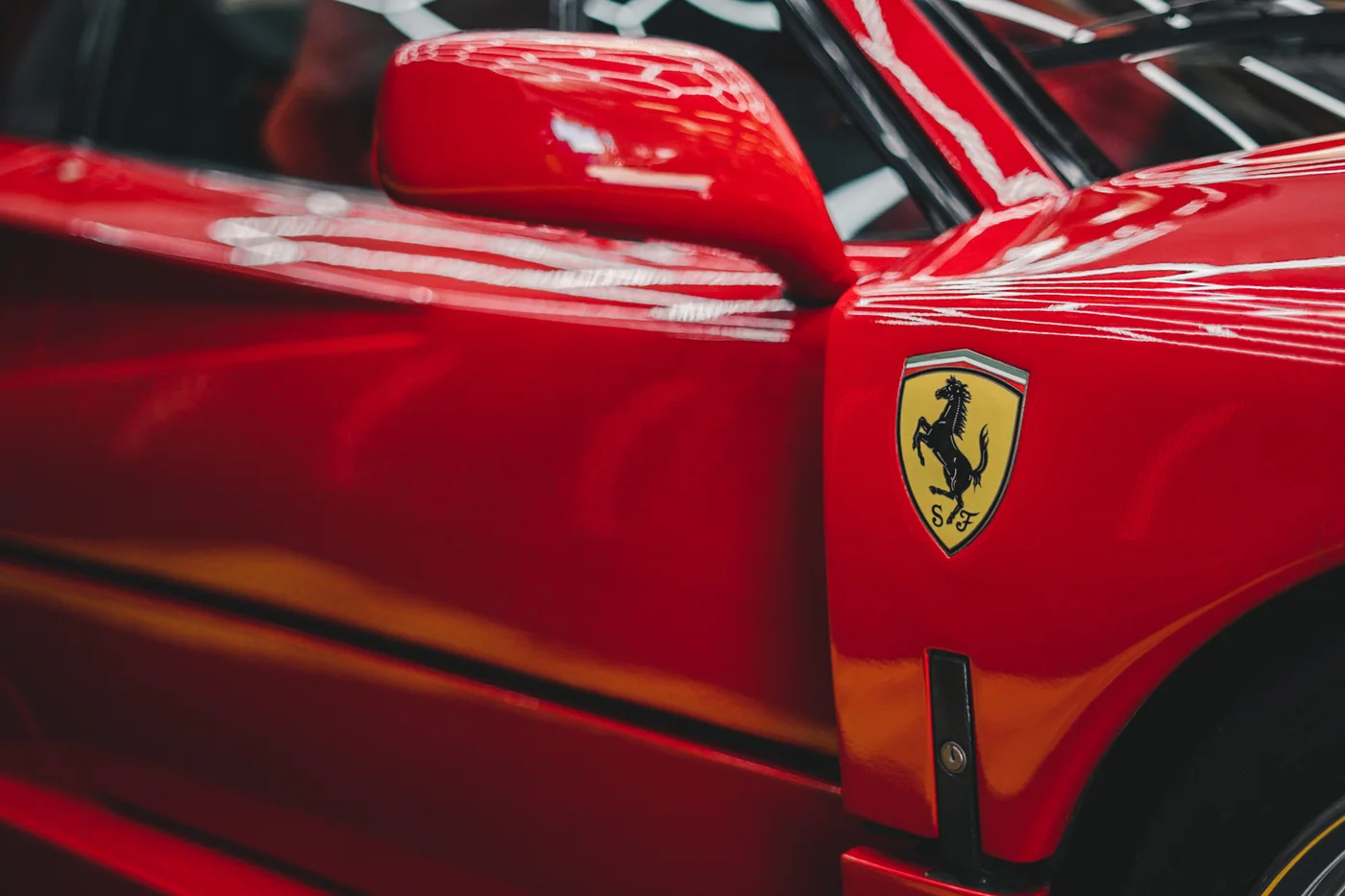 Red Ferrari rear wing and bodywork showing deep gloss after ceramic coating at Artec Automotive
