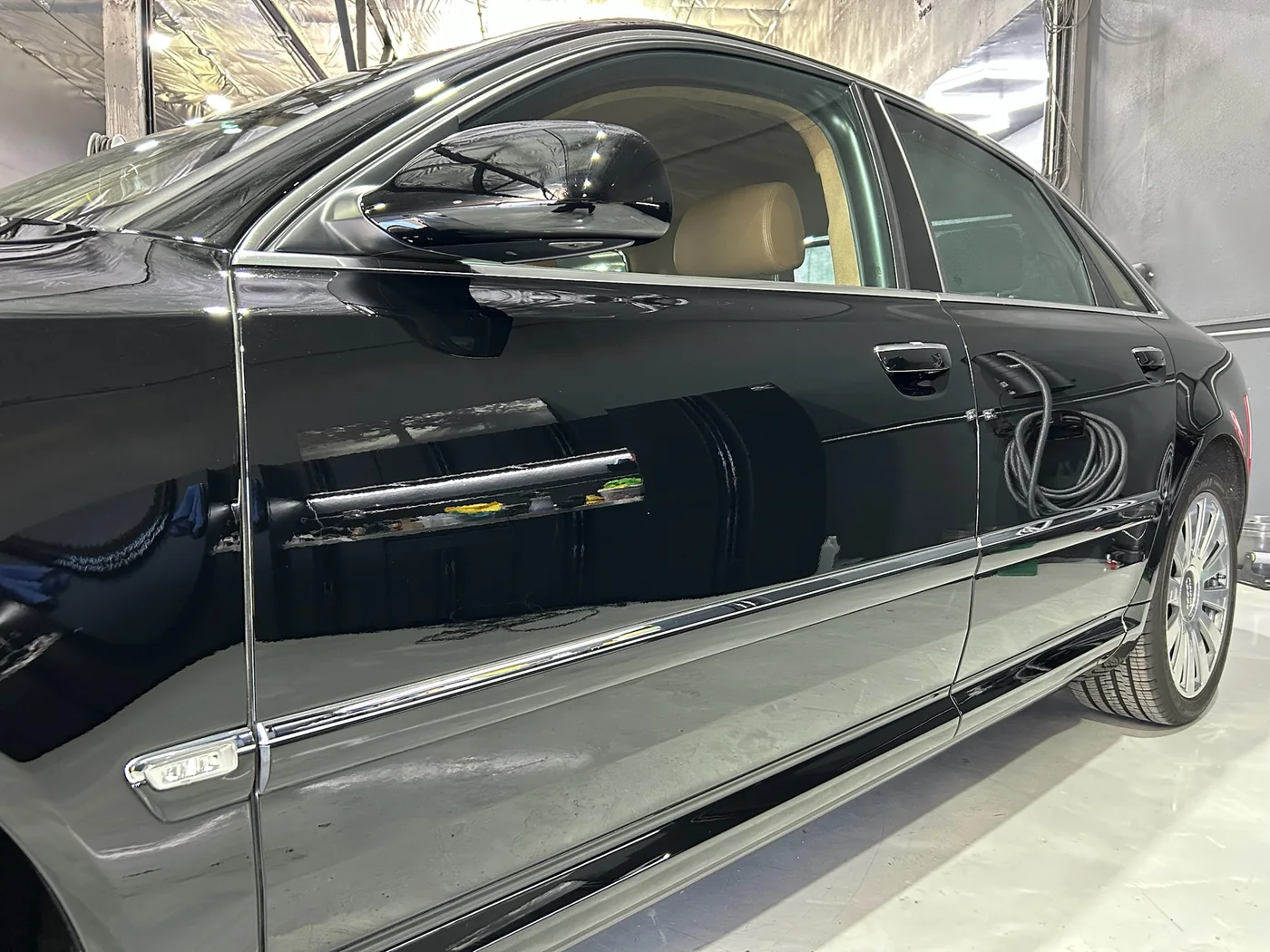 Black Mercedes-Benz saloon with mirror-flat paint following ceramic coating
