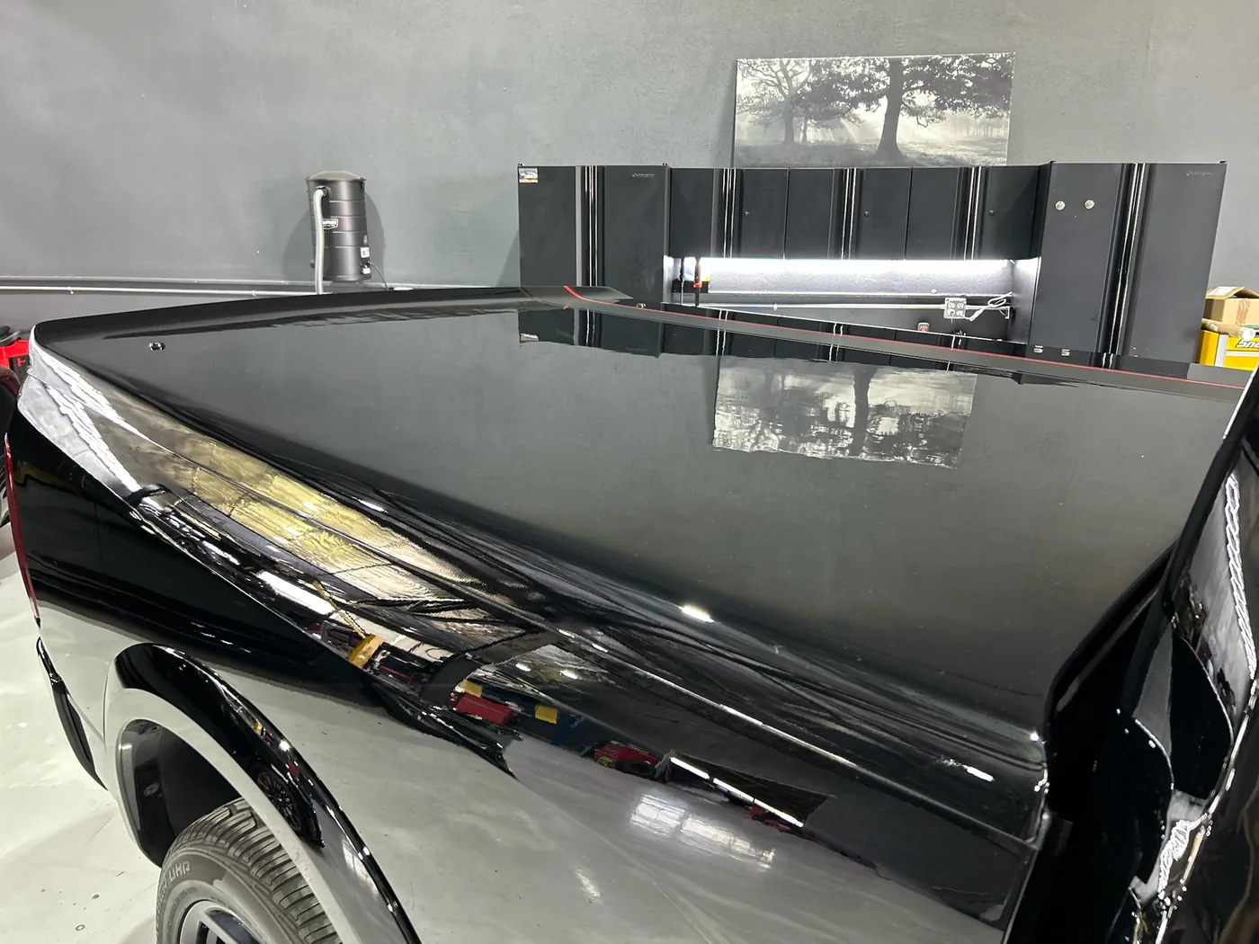 Flank of a black SUV showing reflection detail after ceramic coating at Artec Automotive