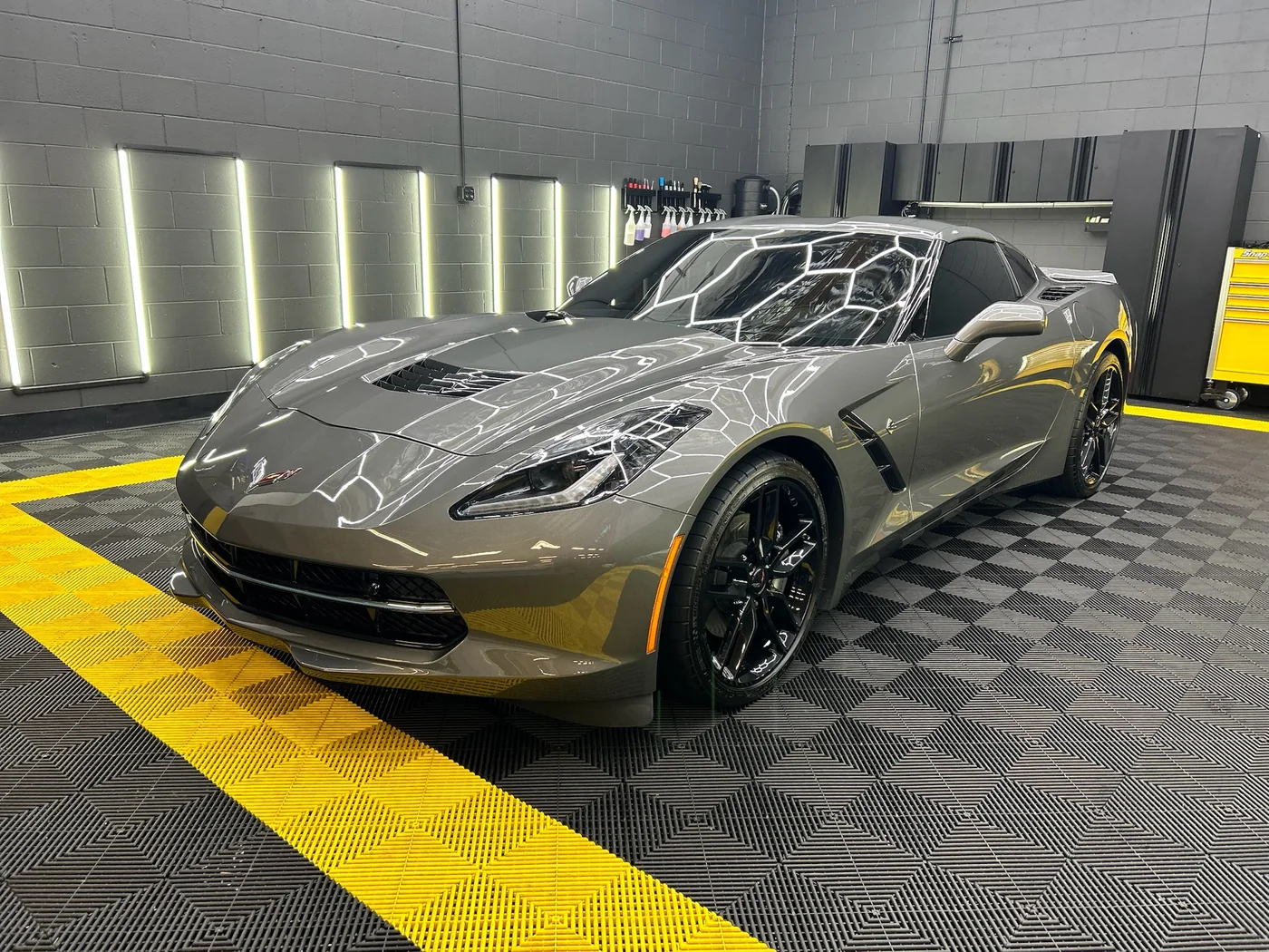 Silver Chevrolet Corvette in the Artec Automotive detailing bay after paint correction