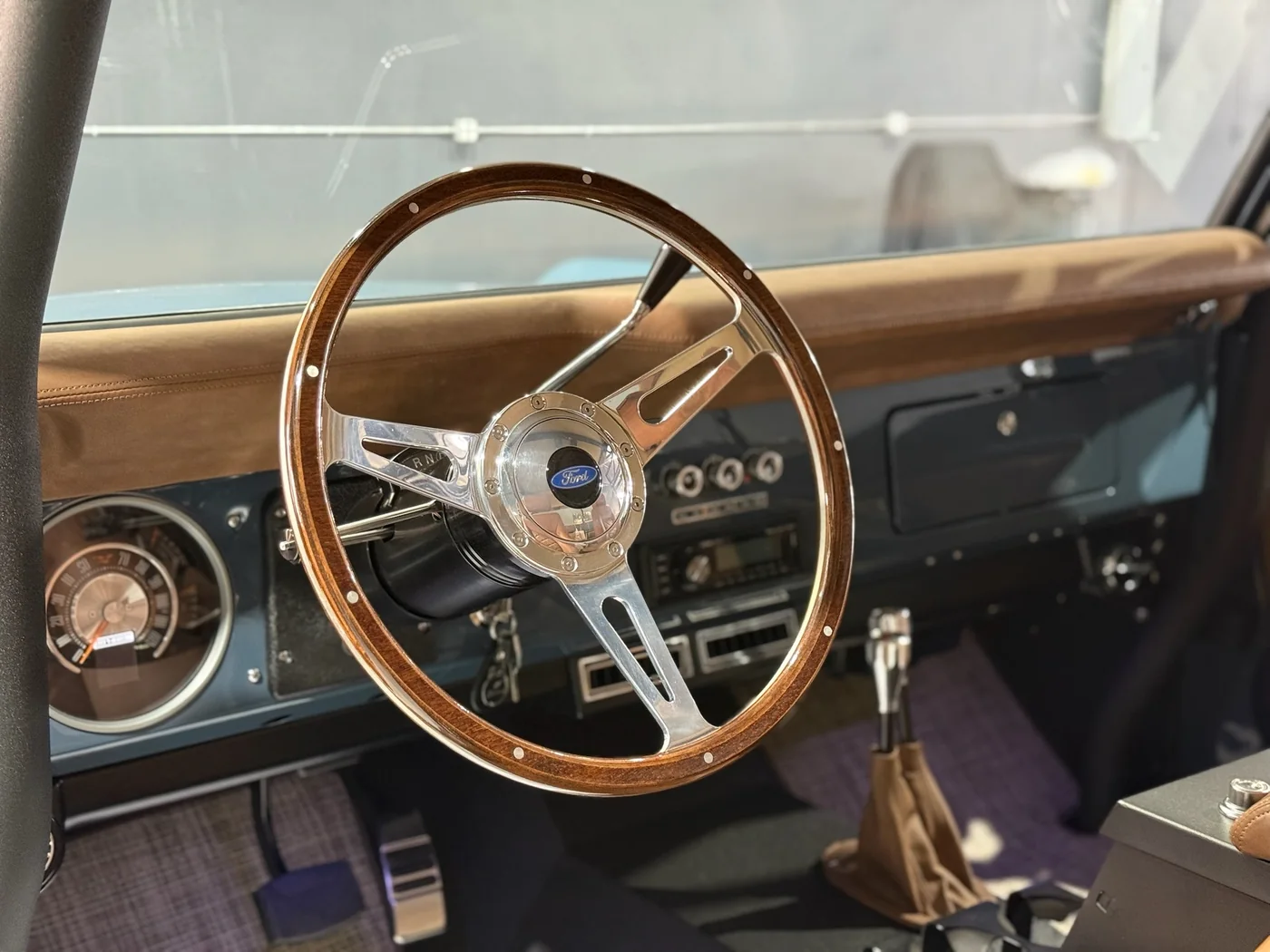 Wood-rimmed steering wheel and interior of a classic car after a full interior clean