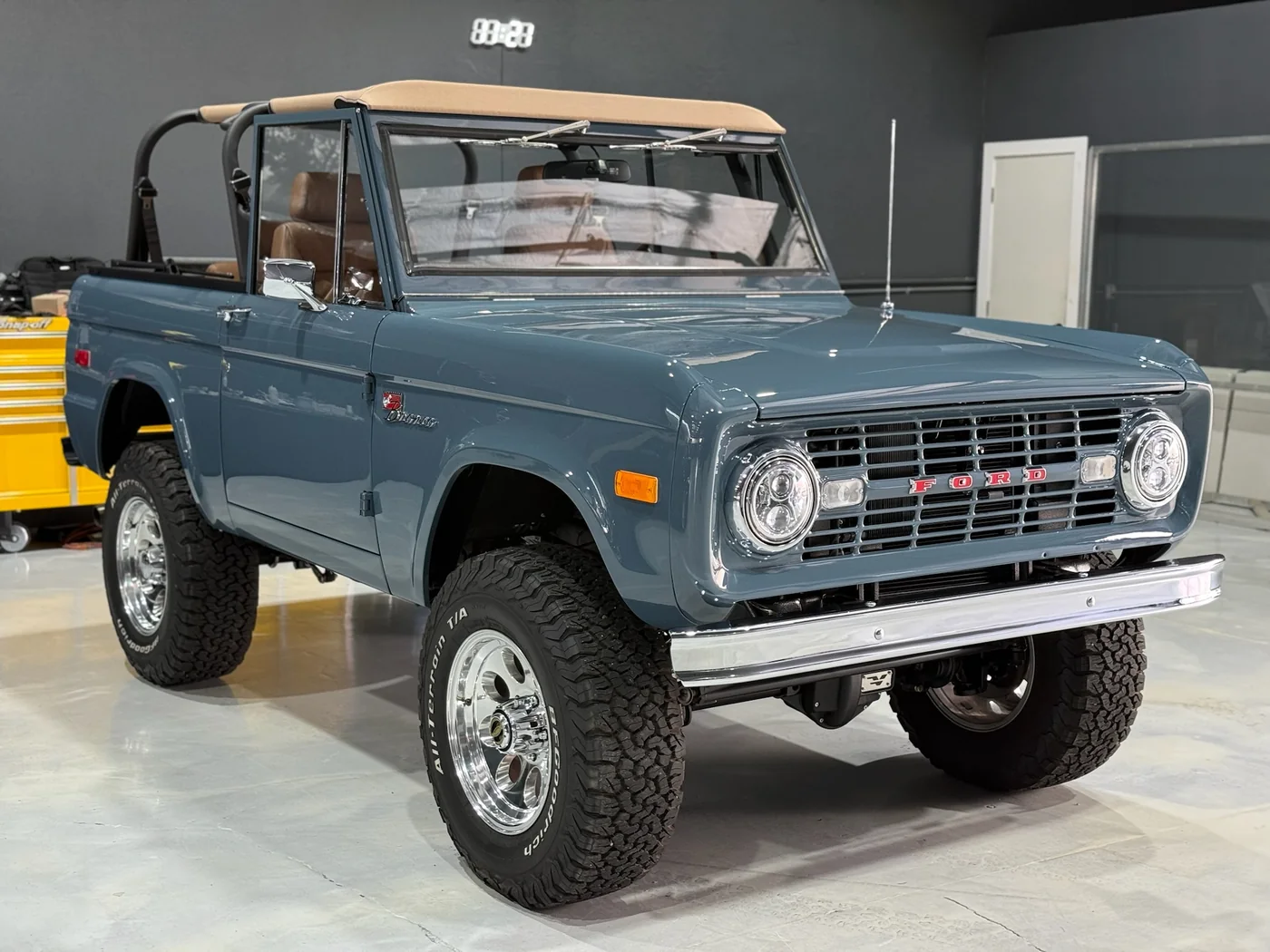 Restored blue-grey Ford Bronco with the soft top down at Artec Automotive in Belmont, CA