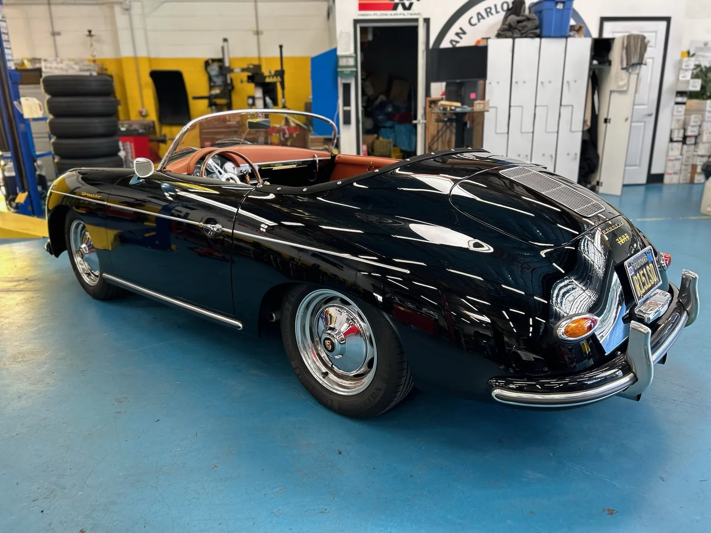 Black Porsche 356 Speedster with tan interior in the Artec Automotive shop