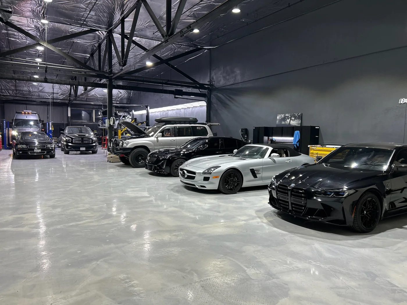 Row of exotic and European cars including a Mercedes SLS AMG in the Artec Automotive shop