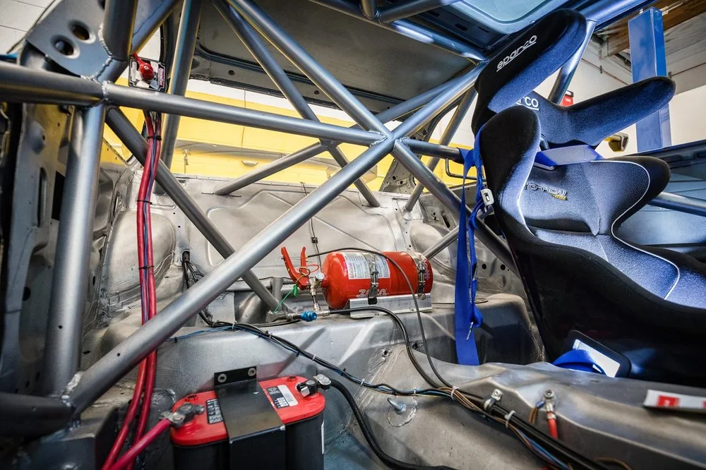 Welded roll cage tubing detail showing cross bracing in a race car build