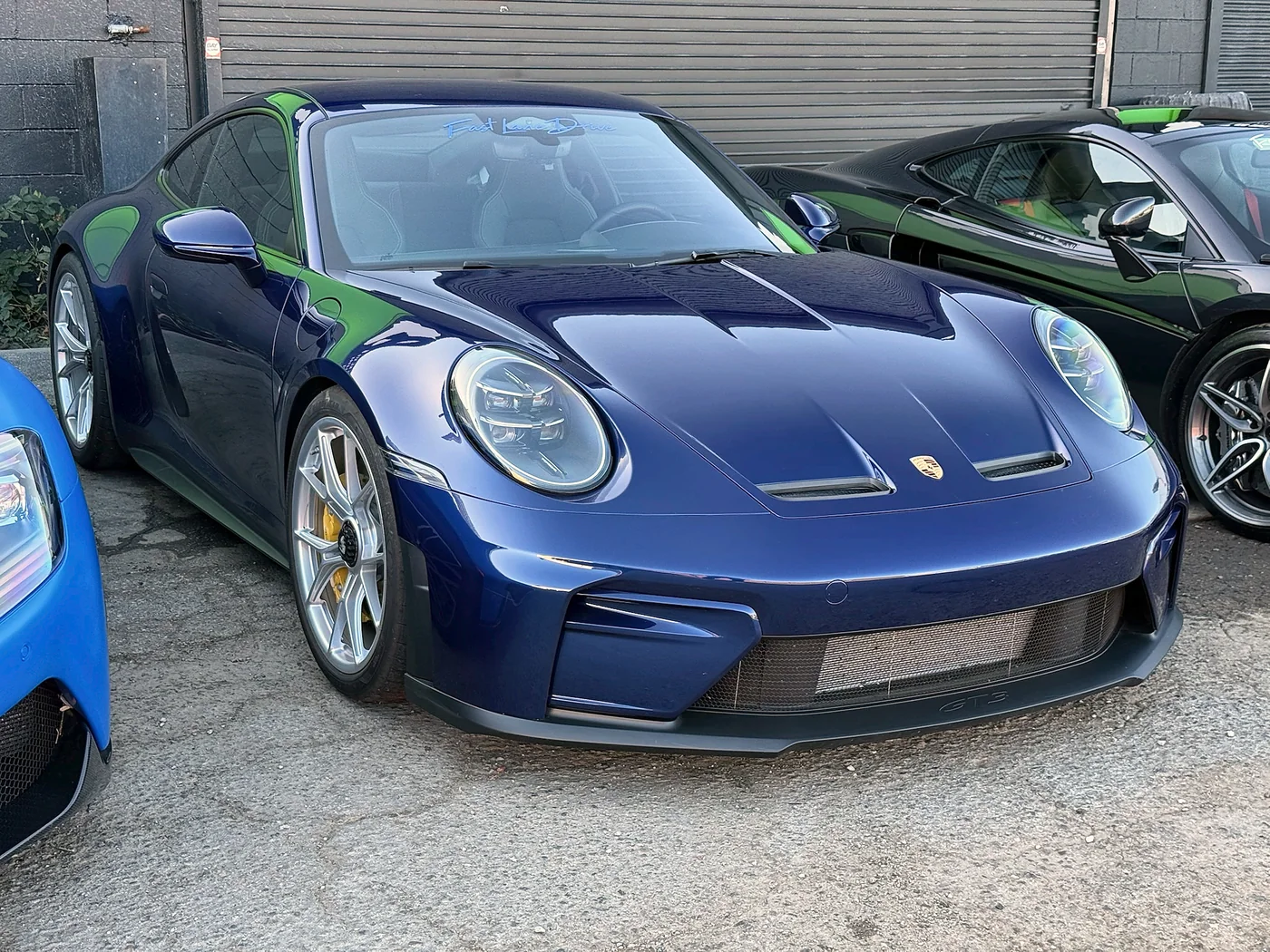 Dark blue Porsche 911 GT3 parked outside Artec Automotive