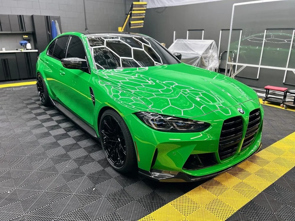 Bright green BMW M3 on the hex tile floor of the Artec Automotive workshop in Belmont, CA