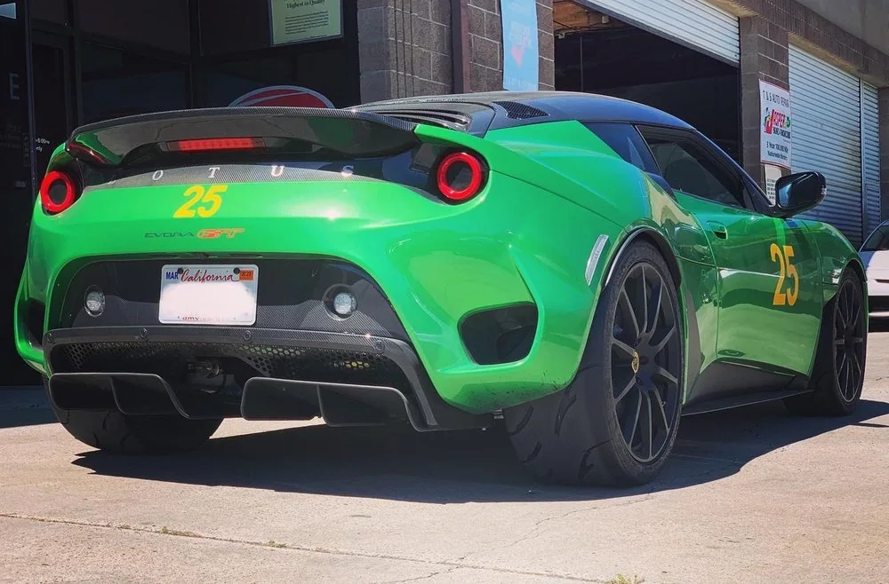 Rear diffuser and exhaust detail of a green Porsche sports car