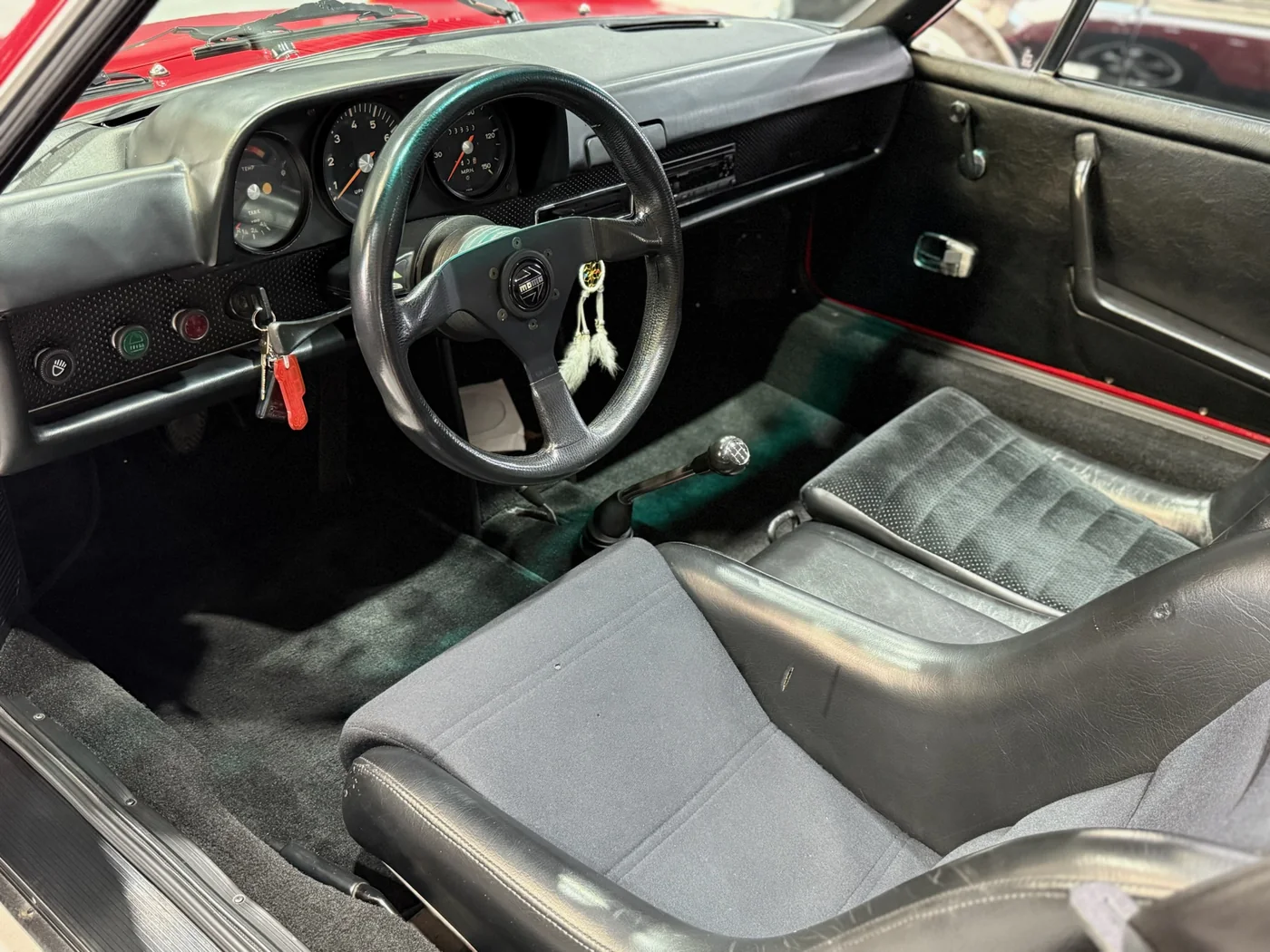 Interior of a classic Porsche 911 with tartan seats undergoing restoration at Artec Automotive