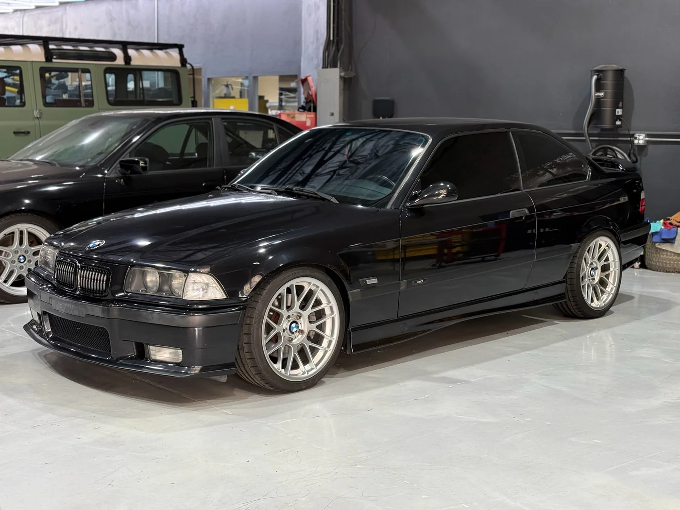 Black BMW E36 with classic BBS wheels in the Artec Automotive shop