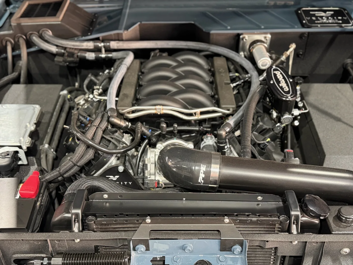 V8 engine bay with custom turbo and exhaust plumbing fabricated at Artec Automotive