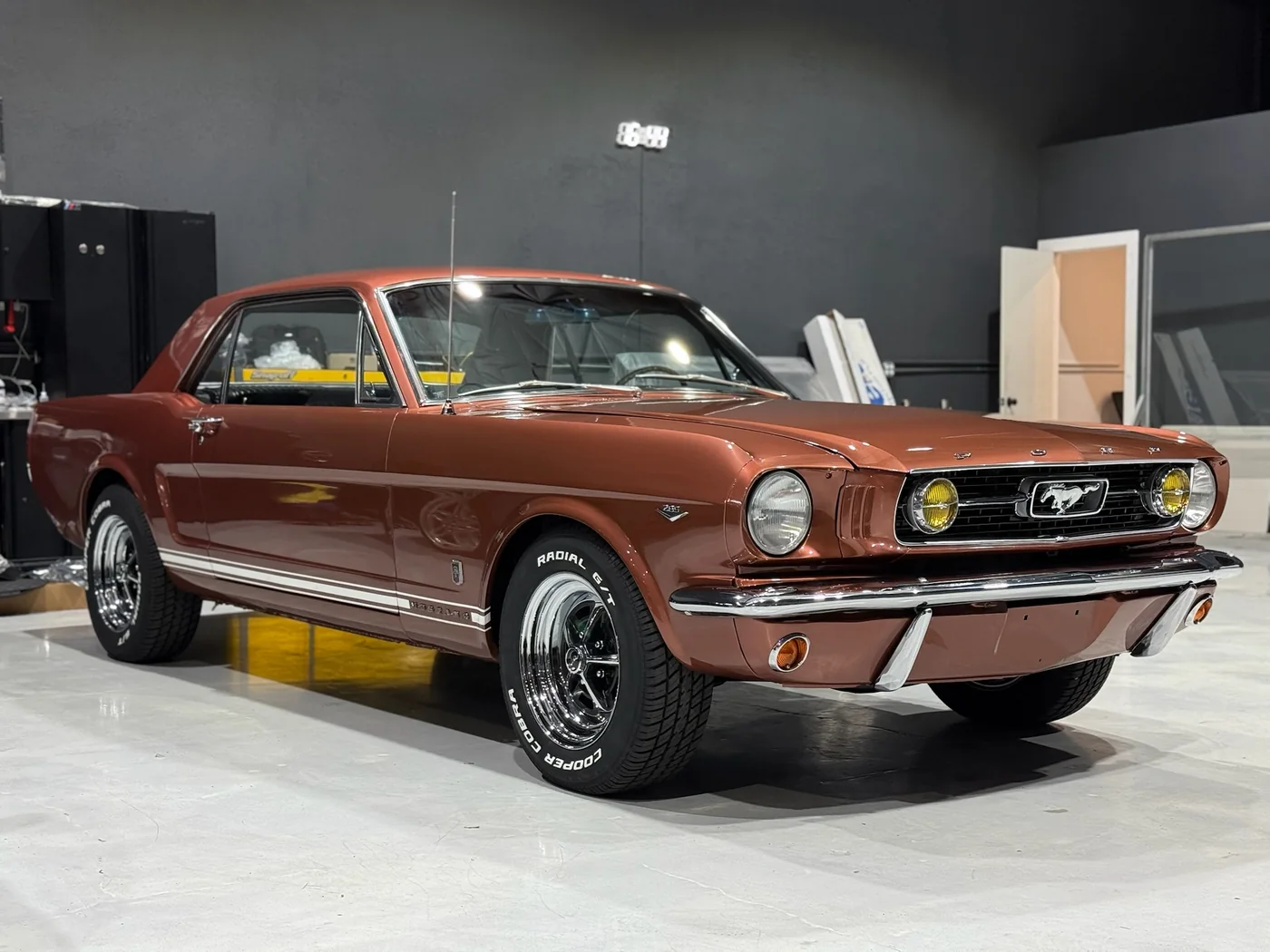 Copper-brown classic Ford Mustang fastback in the Artec Automotive shop