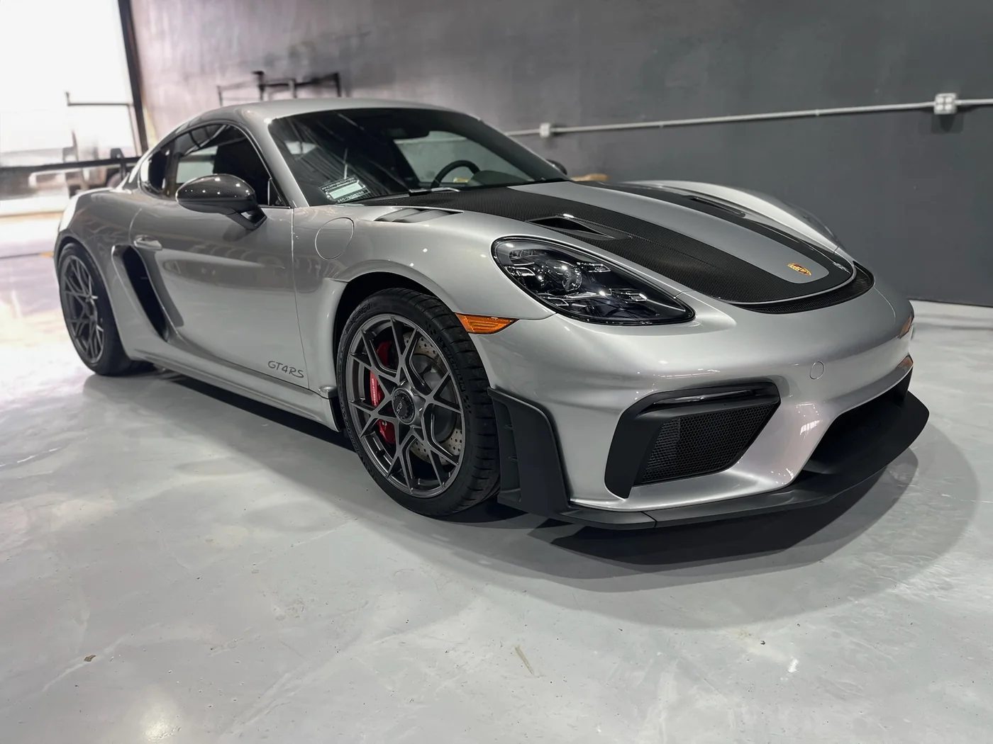 Silver Porsche 718 Cayman GT4 RS on the workshop floor