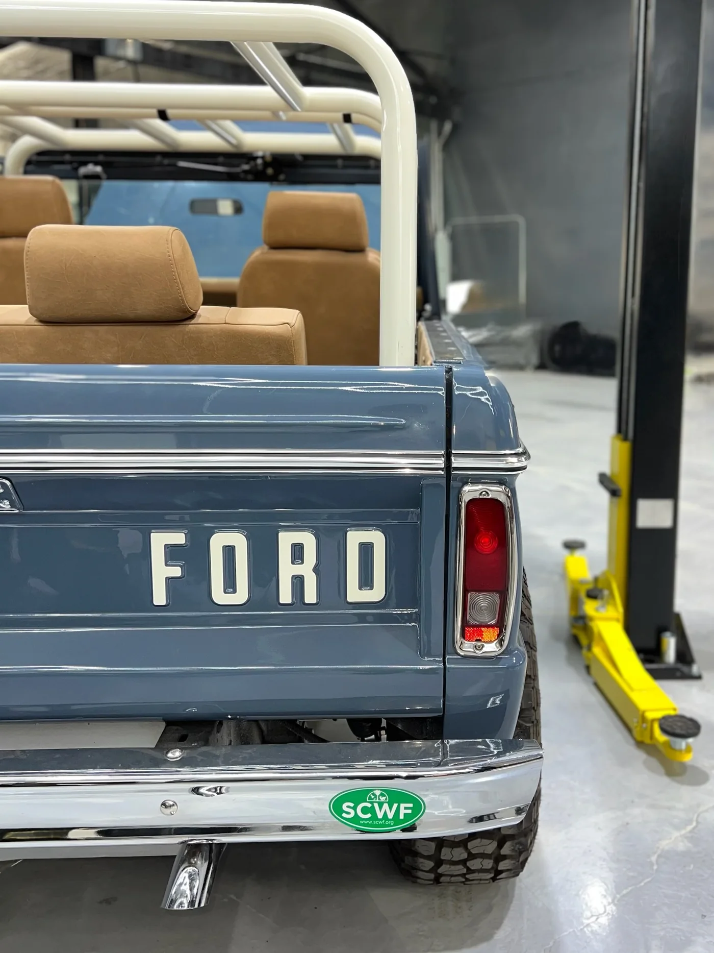 Tailgate of a restored blue Ford pickup truck showing the FORD lettering