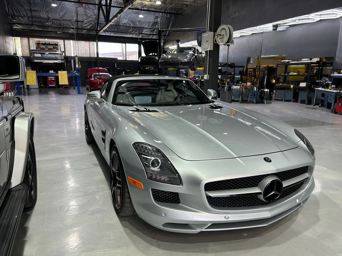 Silver Mercedes-Benz SLS AMG with gullwing doors in the Artec workshop