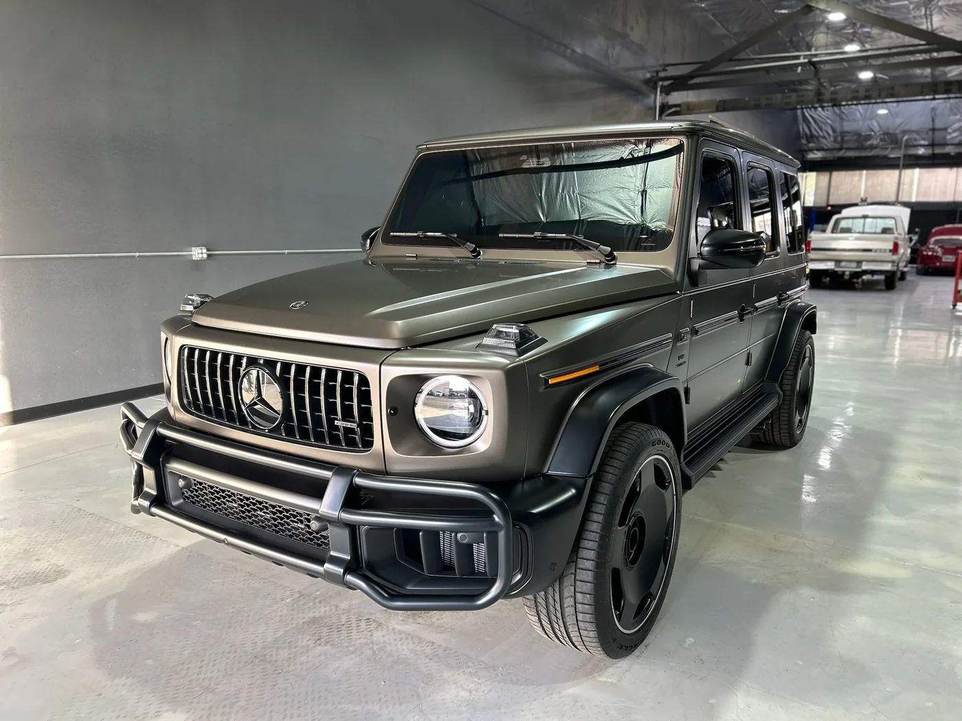 Mercedes-AMG G63 in matte green parked in the service bay