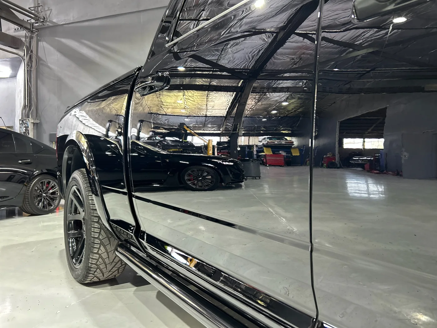 Door and lower panel of a dark SUV after paint protection film installation