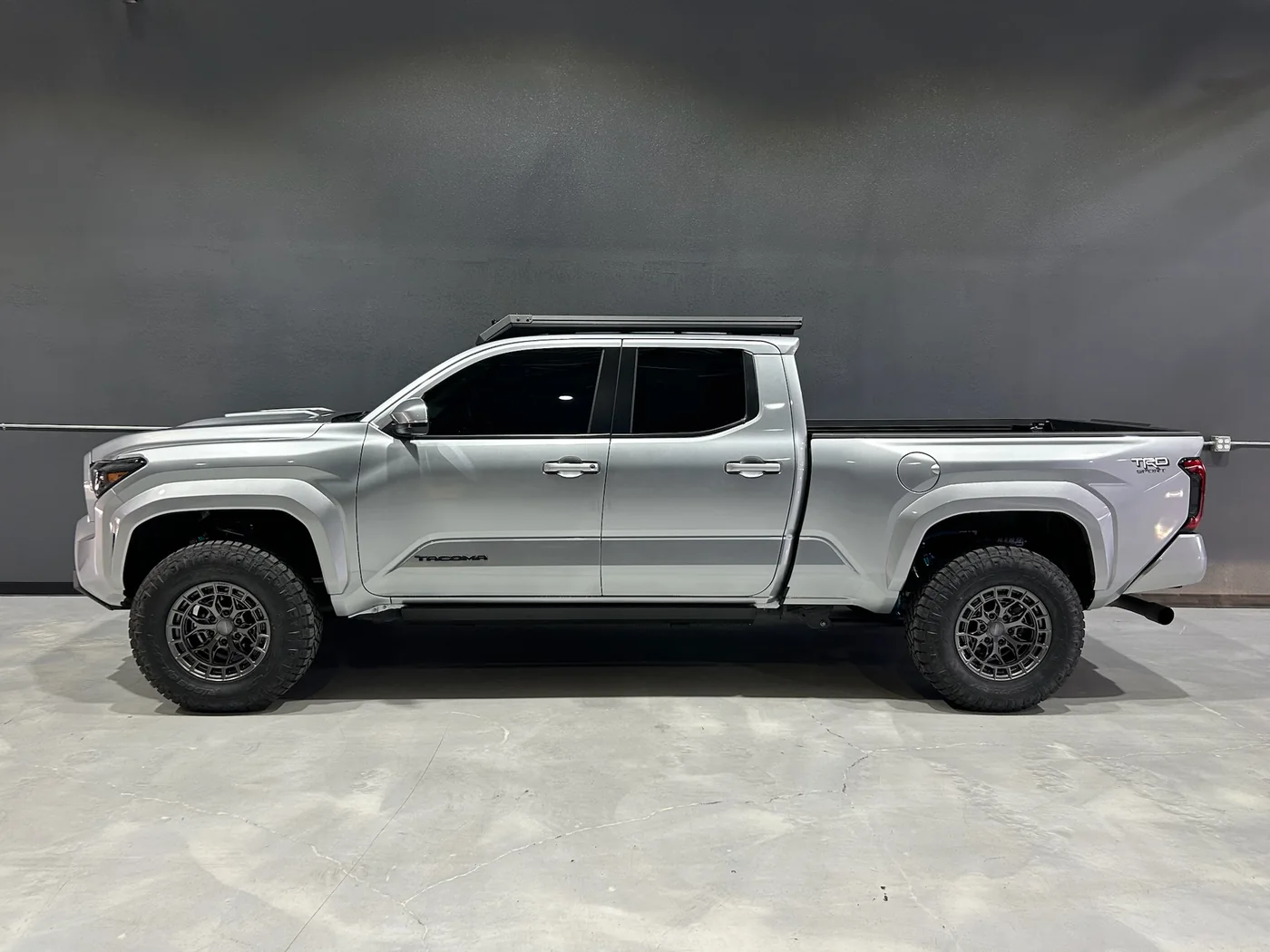 Silver electric pickup truck parked inside the Belmont workshop