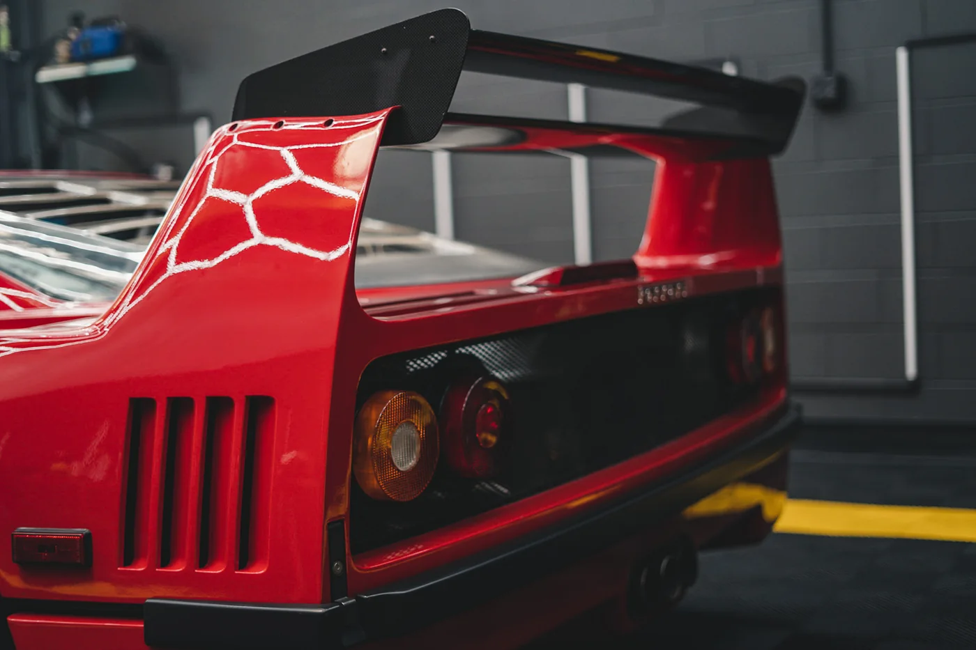 Rear wing and engine cover detail of a red Ferrari F40 at Artec Automotive