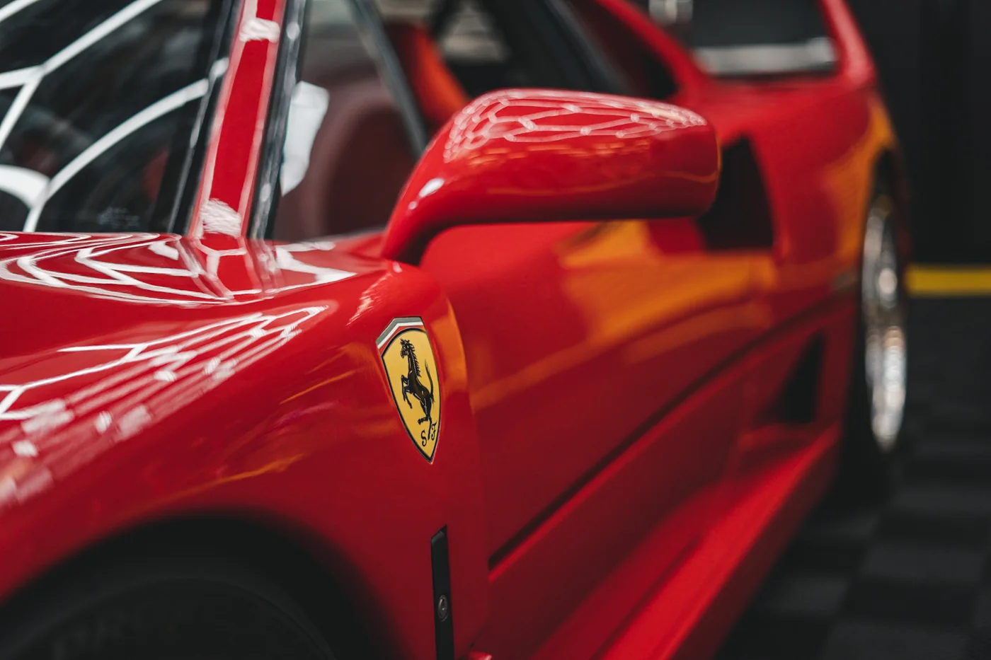 Ferrari shield badge on the front wing of a red Ferrari F40