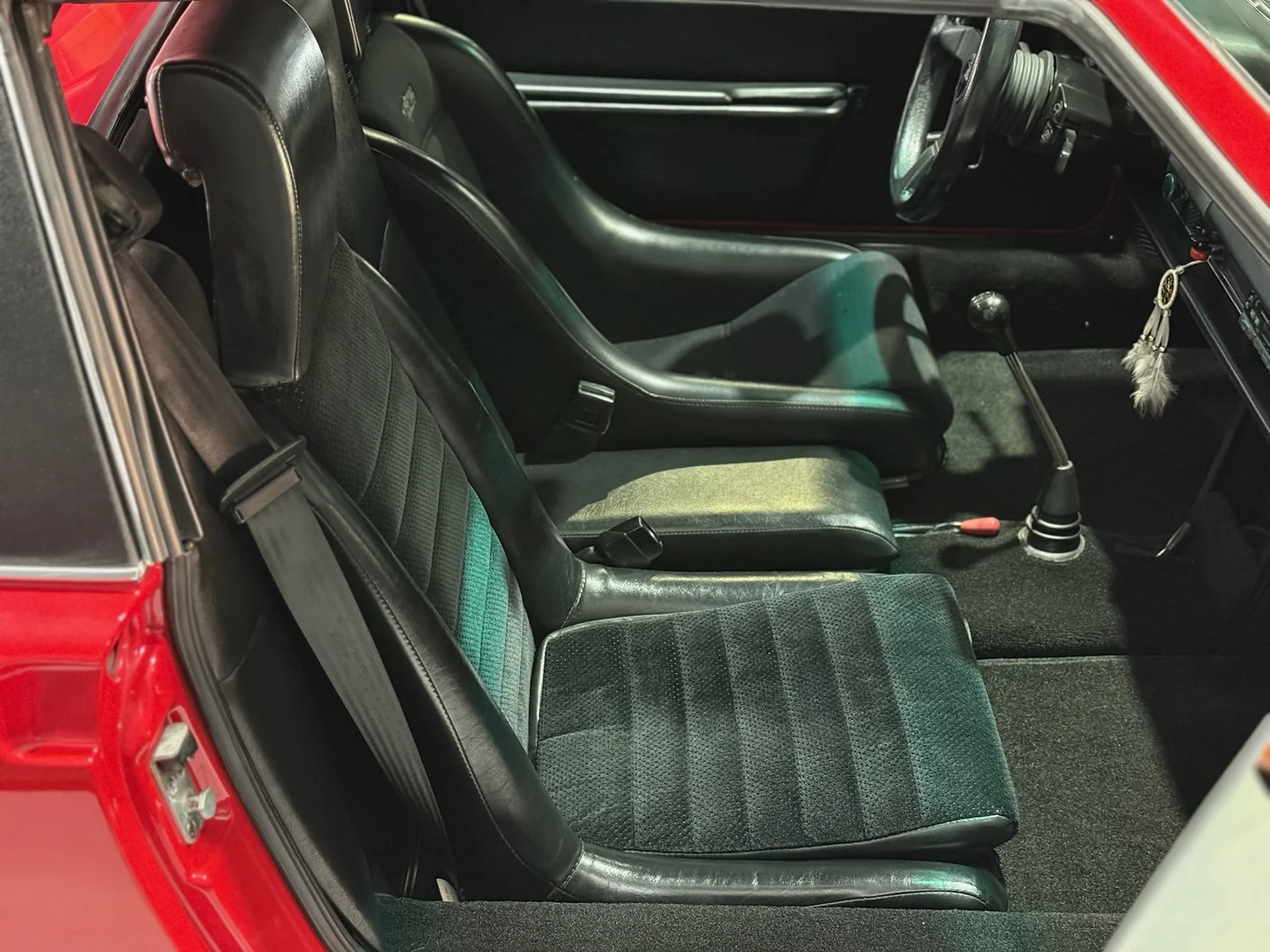 Green leather interior and seats of a classic sports car undergoing restoration