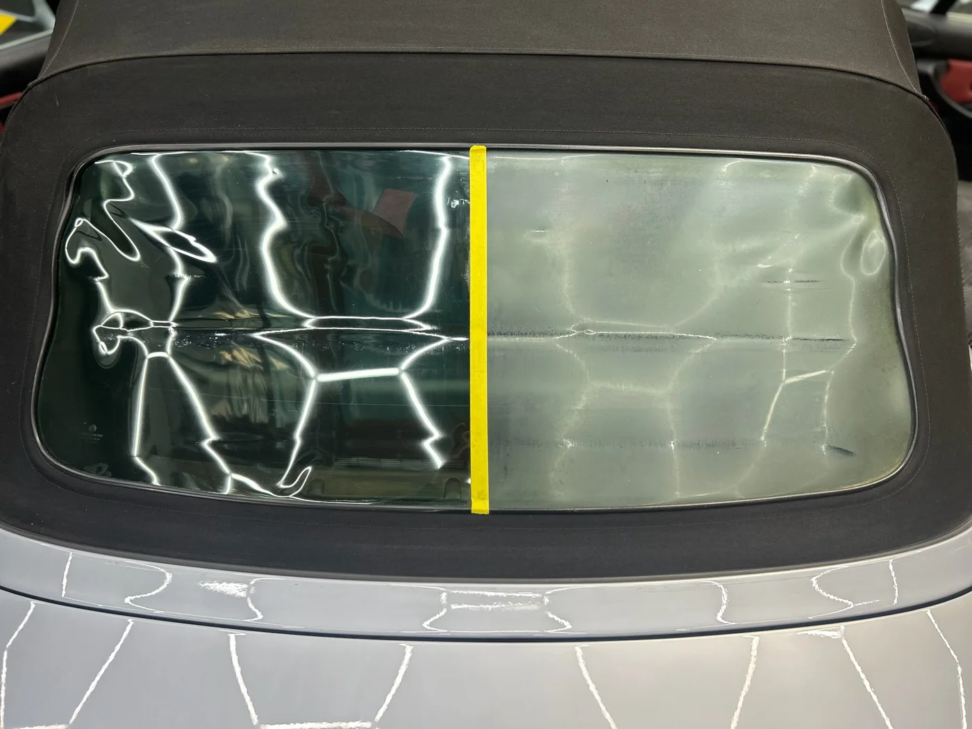 Paint protection film being squeegeed onto a windscreen surround
