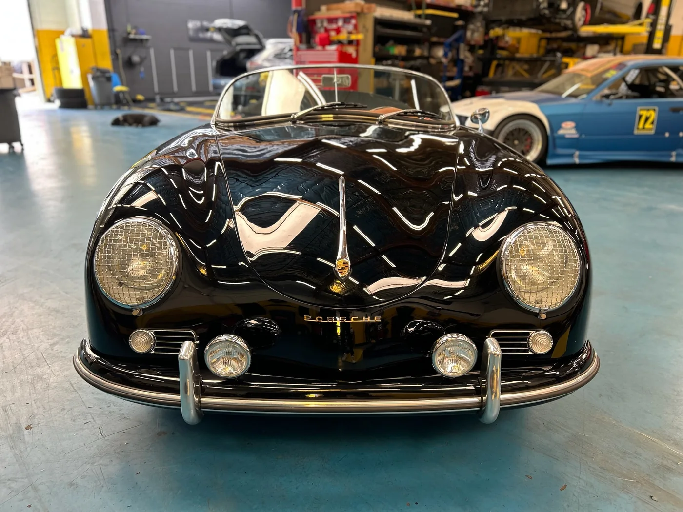Front view of a black classic Porsche 356 in the Artec Automotive workshop
