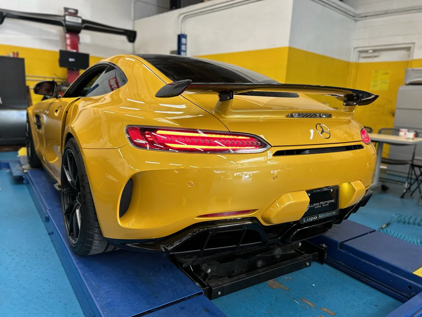 Yellow Mercedes-AMG GT R photographed rear three-quarter in the shop