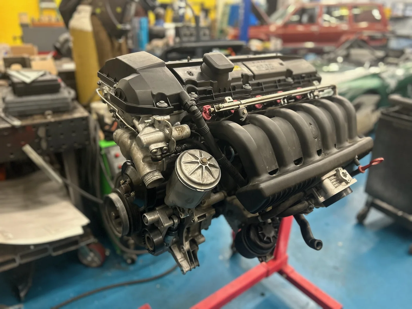 V8 engine removed and mounted on a stand during a rebuild at Artec Automotive