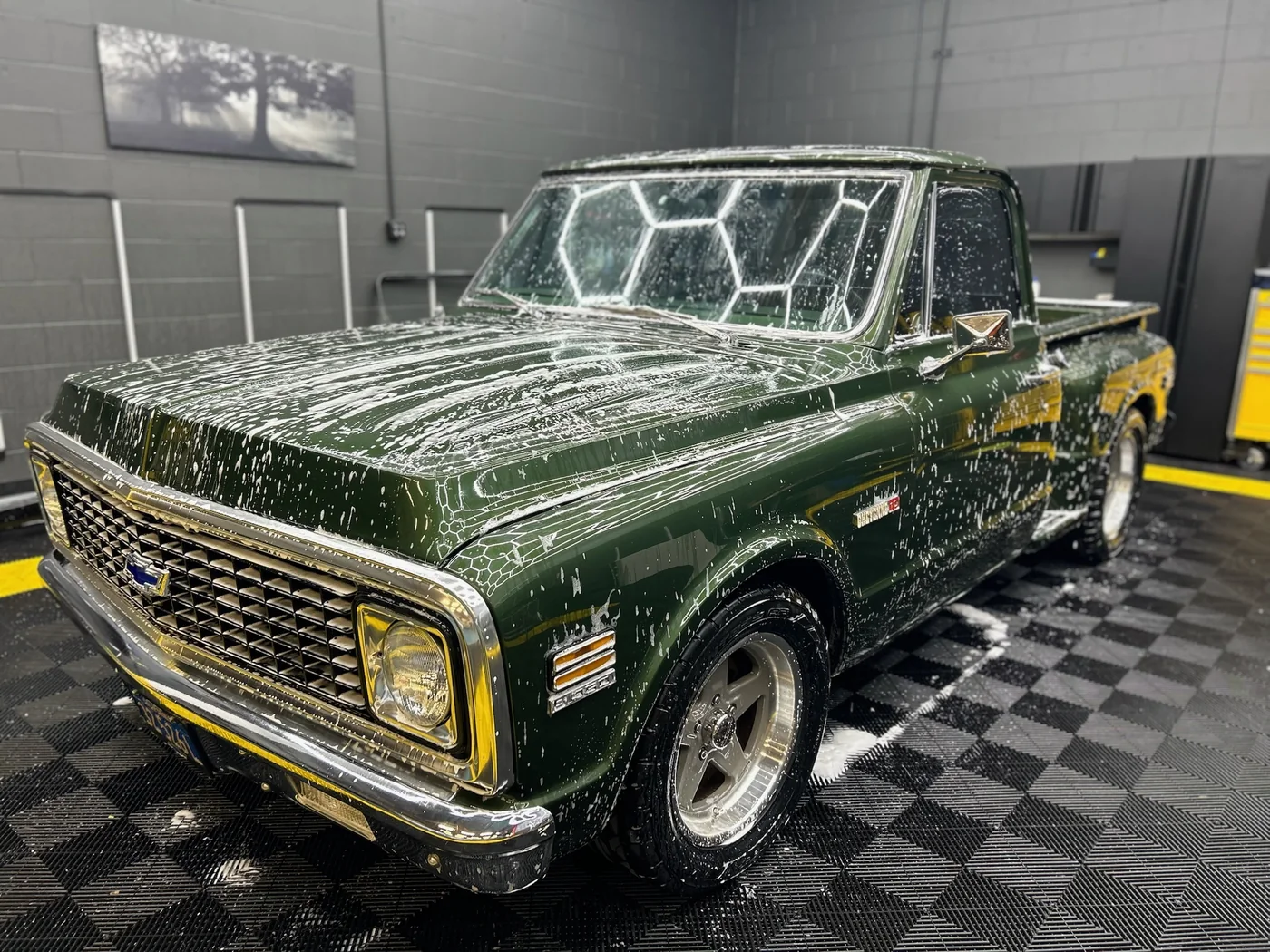 Restored green Chevrolet C10 pickup truck in the workshop