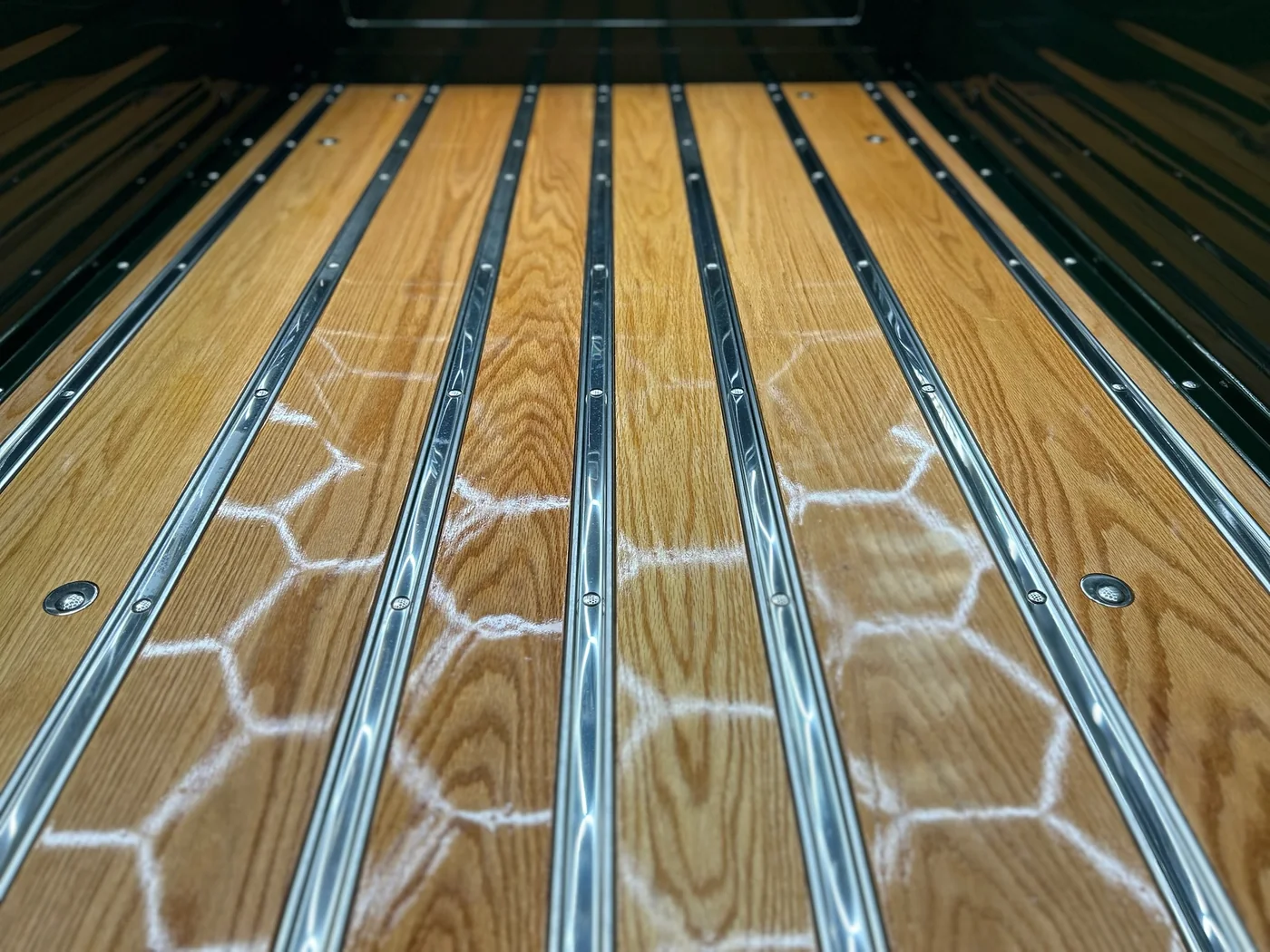 Underside chassis rails and floor pan of a race car during fabrication