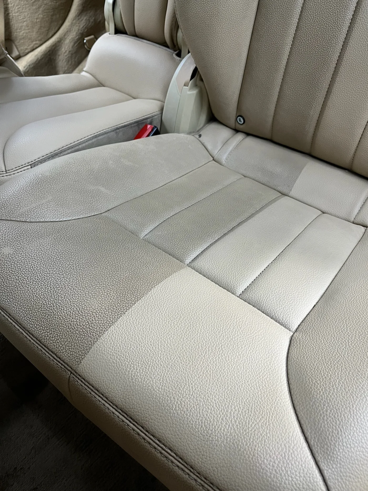 Cream leather rear seat of a classic car after interior restoration