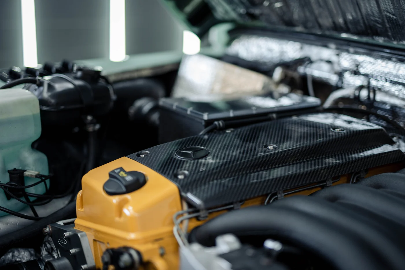 Carbon fibre engine cover on a Mercedes-Benz V8 during service at Artec Automotive in Belmont, CA